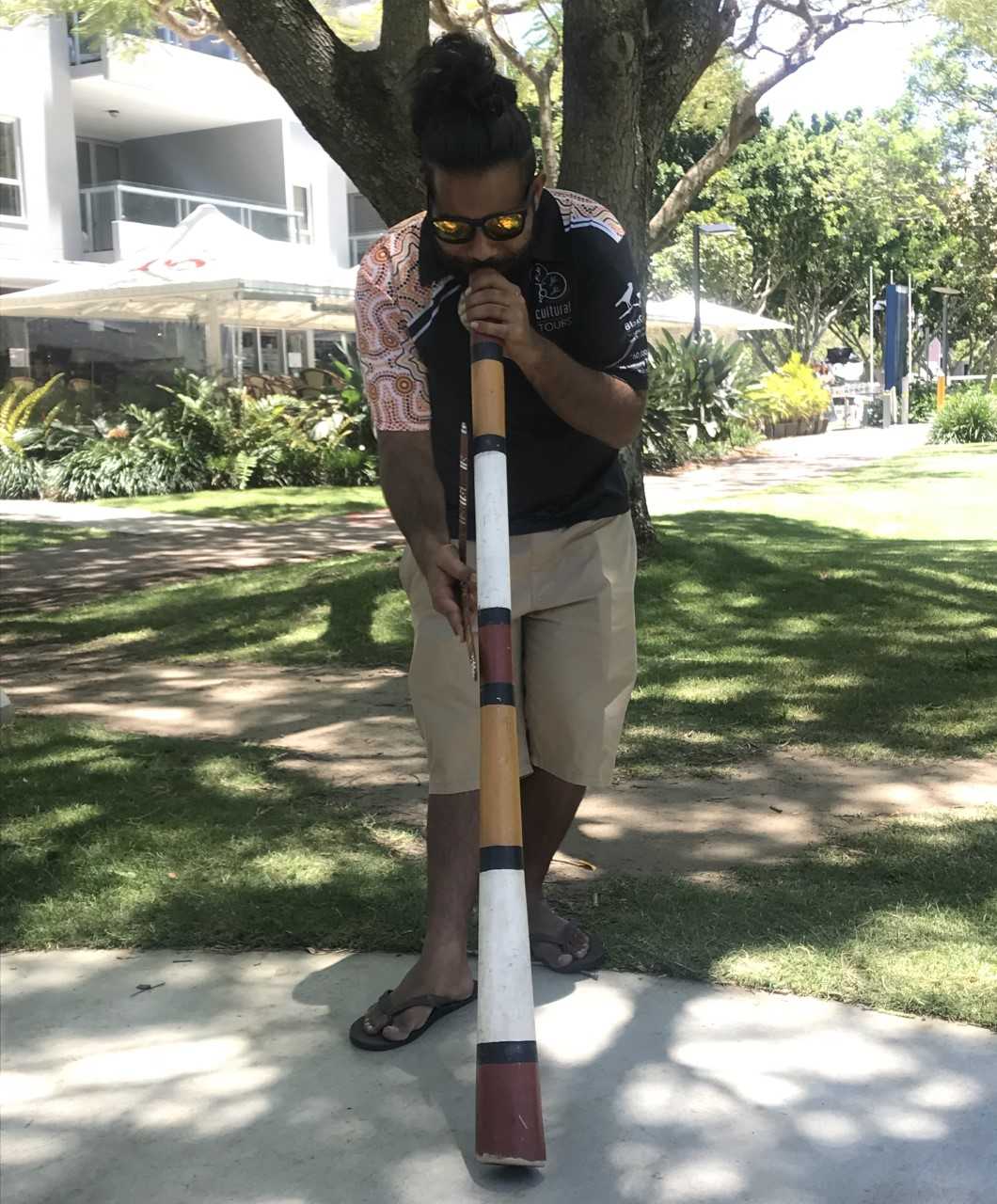 A BlackCard tour guide welcomes the group with a didgeridoo performance