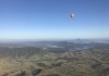 A hot air balloon floats above the hinterland surrounding Brisbane