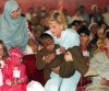 Diana cradles a sick child during a visit to Pakistan in 1996